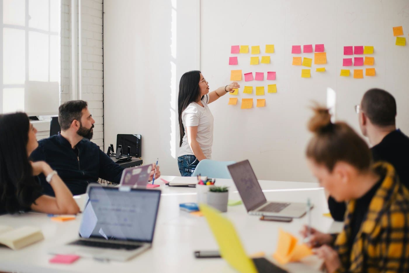 A team planning work on a board of colourful sticky notes